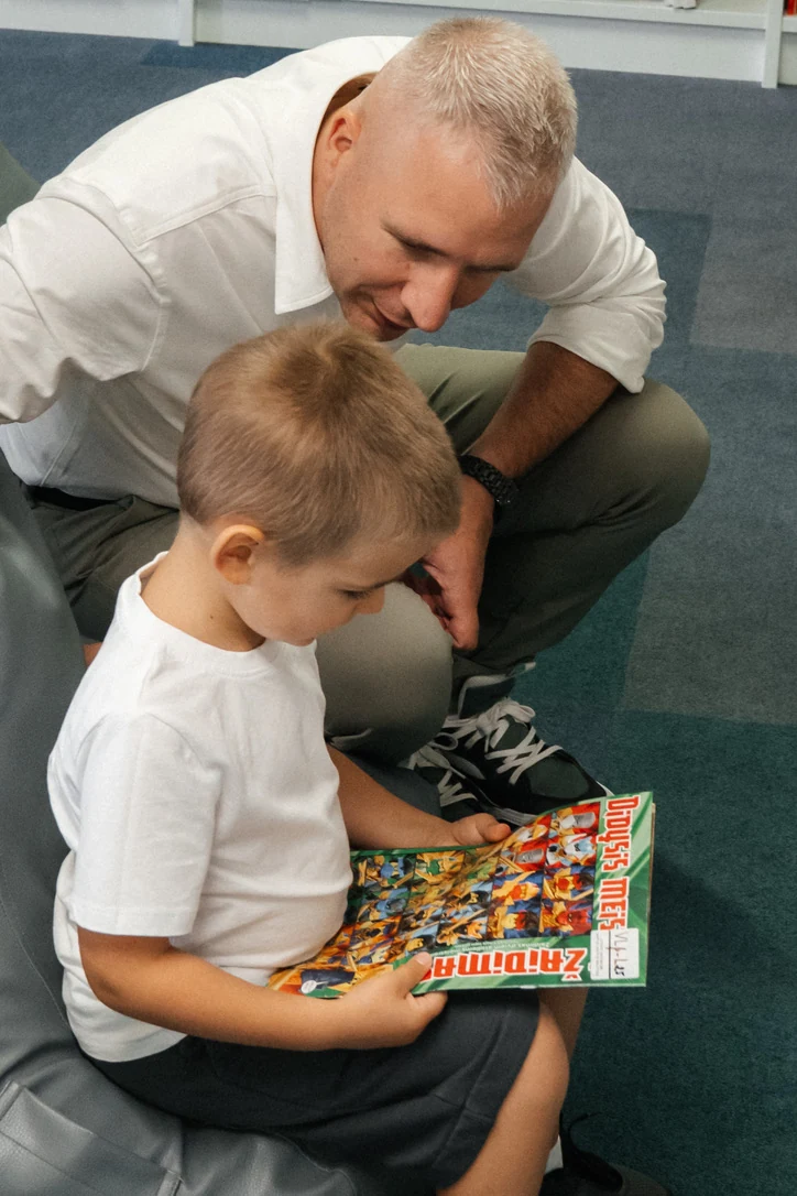 Saulius reading a book with his son Lukas